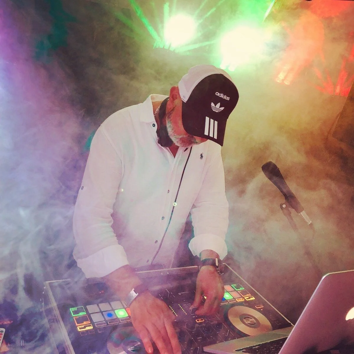 Chico mit Kappe und Kopfhörern an seinem DJ-Pult